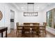 Bright dining room featuring wainscoting, modern light fixture, and an adjacent butler's pantry at 800 Ivy Crest Ln, Canton, GA 30115