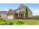 Beautiful home exterior featuring brick, siding, a manicured lawn, and colorful landscaping at 800 Ivy Crest Ln, Canton, GA 30115