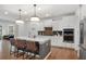 Gourmet kitchen featuring an island with seating, stainless steel appliances, and bright lighting at 800 Ivy Crest Ln, Canton, GA 30115