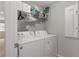 Laundry room with a full-sized washer and dryer and white wire shelving at 800 Ivy Crest Ln, Canton, GA 30115