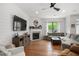 Bright living room featuring hardwood floors, a marble fireplace, and a comfortable sectional sofa at 800 Ivy Crest Ln, Canton, GA 30115