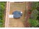 Aerial view of a single-Gathering home, long driveway, and partial view of lawn and surrounding forest at 130 Doris Path, Dallas, GA 30157