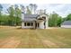 Back exterior of home with covered patio and spacious backyard at 130 Doris Path, Dallas, GA 30157