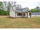 Back exterior view of home with covered patio and spacious backyard at 130 Doris Path, Dallas, GA 30157