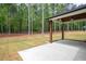 Backyard featuring a covered patio and a spacious lawn surrounded by trees at 130 Doris Path, Dallas, GA 30157