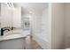 Bright bathroom featuring vanity with granite countertops and tub with shower at 130 Doris Path, Dallas, GA 30157