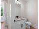 Well-lit powder room featuring a granite countertop, modern fixtures, and an entry door at 130 Doris Path, Dallas, GA 30157