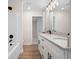 Bright bathroom featuring double vanity with granite countertops and modern lighting at 130 Doris Path, Dallas, GA 30157