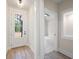 Bright entryway with light wood floors, white trim, and a view into an adjacent room at 130 Doris Path, Dallas, GA 30157