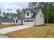 Charming craftsman-style home featuring a two-car garage, gray roof, vertical siding, and well-manicured lawn at 130 Doris Path, Dallas, GA 30157