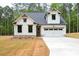 Charming new construction home featuring a white facade, a two-car garage, and a meticulously manicured lawn at 130 Doris Path, Dallas, GA 30157