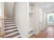 Hallway features a staircase, wooden floors, and built-in storage at 130 Doris Path, Dallas, GA 30157