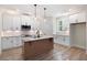Kitchen boasts white cabinets, stainless steel appliances, granite countertops, and a central island at 130 Doris Path, Dallas, GA 30157