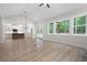 Open-concept living area showcasing hardwood floors, recessed lighting, and large windows at 130 Doris Path, Dallas, GA 30157