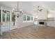 Spacious living room with vaulted ceilings, stone fireplace, built-in shelving, and access to the backyard at 130 Doris Path, Dallas, GA 30157