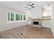 Spacious living room featuring a stone fireplace, modern ceiling fan, and hardwood floors at 130 Doris Path, Dallas, GA 30157