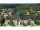 Aerial view of a community with homes surrounding a serene lake with wooded scenery at 2436 Camden Lake Nw Vw, Acworth, GA 30101