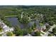 Lush, green neighborhood homes surround a lake with tree-covered islands in a beautiful aerial perspective at 2436 Camden Lake Nw Vw, Acworth, GA 30101