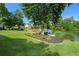 Expansive backyard with lush lawn, mature trees, and a tranquil lake, plus a wooden deck for enjoying the scenery at 2436 Camden Lake Nw Vw, Acworth, GA 30101