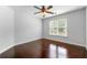 Bedroom with hardwood floors, a ceiling fan, and large window letting in natural light at 2436 Camden Lake Nw Vw, Acworth, GA 30101