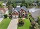 Beautiful two-story brick home with a well-manicured lawn, mature trees and a lake view at 2436 Camden Lake Nw Vw, Acworth, GA 30101