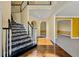 Inviting foyer with hardwood floors, staircase with stone accents, and arched doorways leading to other rooms at 2436 Camden Lake Nw Vw, Acworth, GA 30101