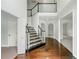 Bright foyer with hardwood floors, stone-accented staircase, and an open view to adjacent rooms at 2436 Camden Lake Nw Vw, Acworth, GA 30101