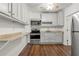 Charming kitchen with stainless steel appliances, light grey cabinets, and wood-look flooring at 2436 Camden Lake Nw Vw, Acworth, GA 30101