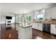Open concept kitchen with white cabinets, granite countertops, hardwood floors and stainless steel appliances at 2436 Camden Lake Nw Vw, Acworth, GA 30101