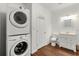 This laundry room features a stackable washer and dryer, sink and storage at 2436 Camden Lake Nw Vw, Acworth, GA 30101