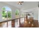 Bright living room featuring hardwood floors, vaulted ceilings, large windows with a view of the lake at 2436 Camden Lake Nw Vw, Acworth, GA 30101