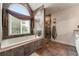 Luxurious main bathroom featuring a soaking tub, tiled shower, decorative tiles, and a large window at 2436 Camden Lake Nw Vw, Acworth, GA 30101