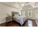 Main bedroom with tray ceilings, a ceiling fan, two windows, hardwood floors and neutral decor at 2436 Camden Lake Nw Vw, Acworth, GA 30101