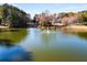 Picturesque community pond with a fountain and trees at 2436 Camden Lake Nw Vw, Acworth, GA 30101