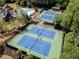 This tennis court complex contains lighting, fencing, a covered pergola, and landscaping at 2436 Camden Lake Nw Vw, Acworth, GA 30101