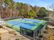 Outdoor tennis courts surrounded by trees and black fencing at 2436 Camden Lake Nw Vw, Acworth, GA 30101