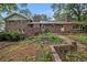 Exterior view of a beautiful brick home with a well-maintained backyard and mature trees at 3743 Tree Bark Trl, Decatur, GA 30034