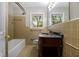 Bathroom featuring tiled walls, a vanity with a marble top, and a bathtub with shower at 3743 Tree Bark Trl, Decatur, GA 30034