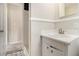 Bathroom features a white single sink vanity, black and white tiled floors, and a shower-tub combo at 3743 Tree Bark Trl, Decatur, GA 30034