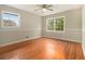 Bright bedroom with hardwood floors, a ceiling fan, and two windows offering ample natural light at 3743 Tree Bark Trl, Decatur, GA 30034