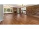 Spacious living room with a brick fireplace, modern flooring, and an open view to the kitchen at 3743 Tree Bark Trl, Decatur, GA 30034