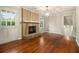 Cozy living room with a brick fireplace, hardwood floors, and a door to the outside at 3743 Tree Bark Trl, Decatur, GA 30034