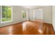 Bright living room with gleaming hardwood floors and large windows showcasing the outdoor view at 3743 Tree Bark Trl, Decatur, GA 30034