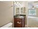 Granite countertop, wood cabinet and sink in bathroom with an open doorway at 7104 Santa Fe Pkwy, Atlanta, GA 30350