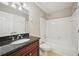 Bathroom featuring a granite countertop, wood cabinet, and tub with shower at 7104 Santa Fe Pkwy, Atlanta, GA 30350