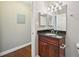 Bathroom featuring granite countertop, wood cabinet, vanity mirror, and tile flooring at 7104 Santa Fe Pkwy, Atlanta, GA 30350