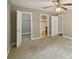 Spacious bedroom featuring carpet floors, a ceiling fan, and multiple access doors, adding functionality and charm at 7104 Santa Fe Pkwy, Atlanta, GA 30350