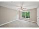 Bedroom with neutral walls, carpet, ceiling fan and window with tree view at 7104 Santa Fe Pkwy, Atlanta, GA 30350