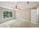 A bedroom showing a ceiling fan and a large window, creating a bright and airy feel in the space at 7104 Santa Fe Pkwy, Atlanta, GA 30350
