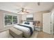 This bedroom features neutral walls, a ceiling fan, and a large window for ample natural lighting at 7104 Santa Fe Pkwy, Atlanta, GA 30350